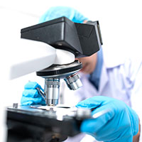 technician using a biotech microscope